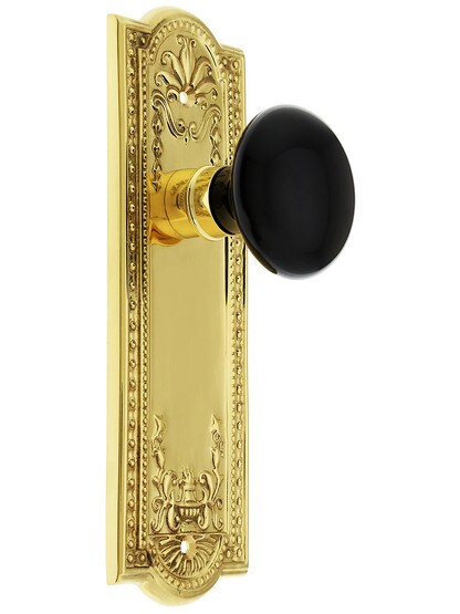 Meadows Style Door Set with Black Porcelain Knobs without Keyhole in Unlacquered Brass.